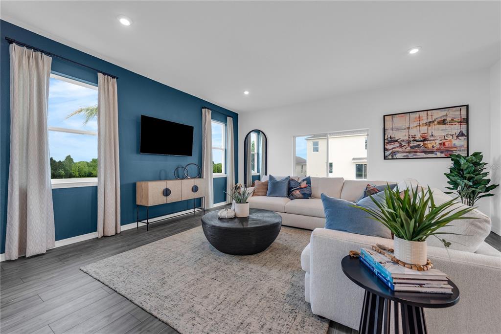 643 Rockaway Lane Cocoa, FL 32927 - Photo 2 of 34 a living room with furniture a flat screen tv and a large window