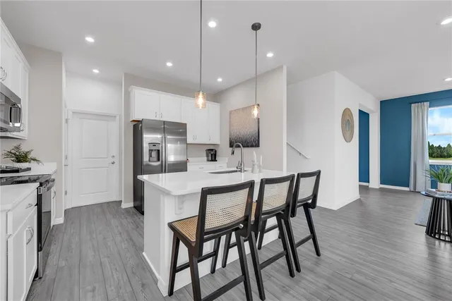 a kitchen with a sink stainless steel appliances and cabinets