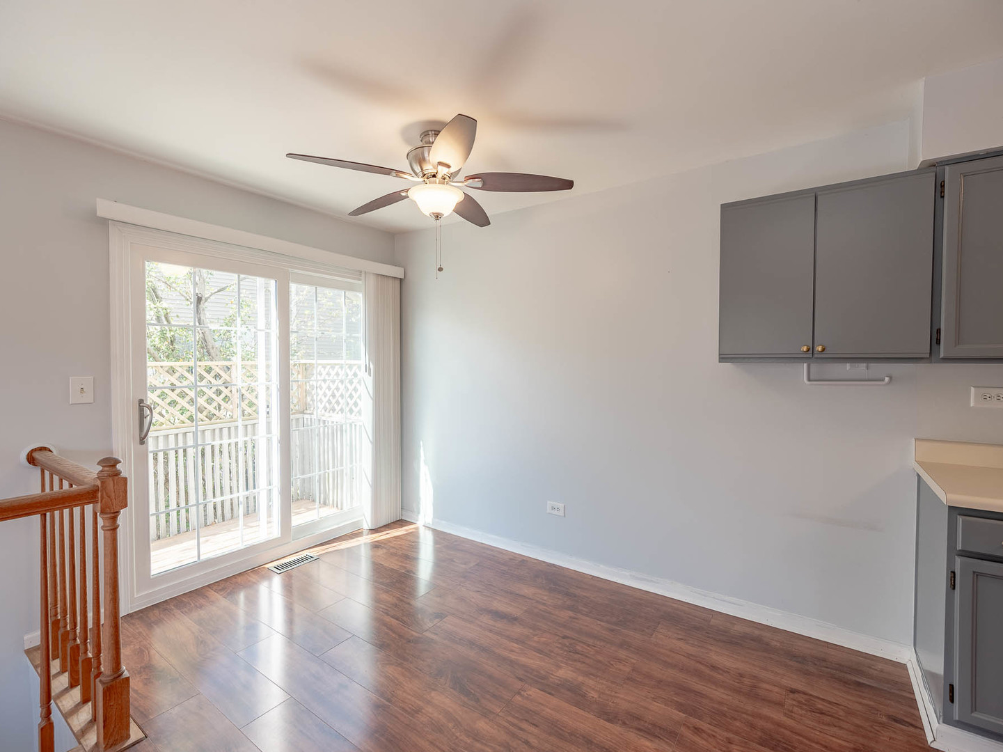 2214 Colorado Avenue, Unit 2214 Elgin, IL 60123 - Photo 5 of 14 a view of empty room with wooden floor and fan