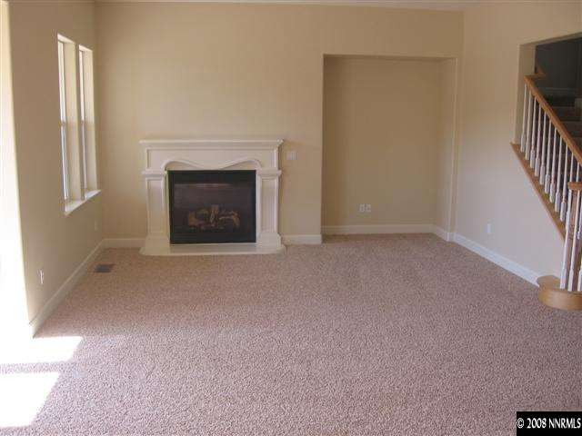 8564 Timaru Trail Reno, NV 89523 - Photo 7 of 8 a view of an empty room with a fireplace and a window