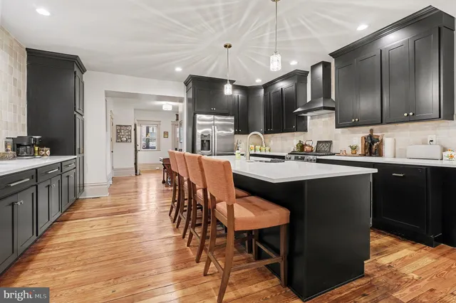 a kitchen with a table chairs sink and cabinets