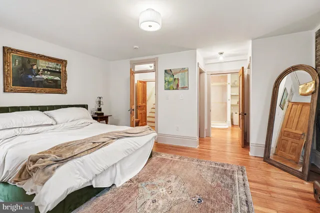 a spacious bedroom with a bed and a walk in closet