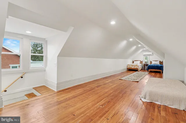 a view of a room with wooden floor and windows