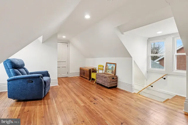 a bedroom with furniture and wooden floor