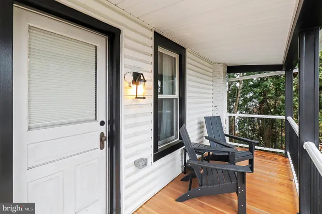 a balcony with with table and chairs