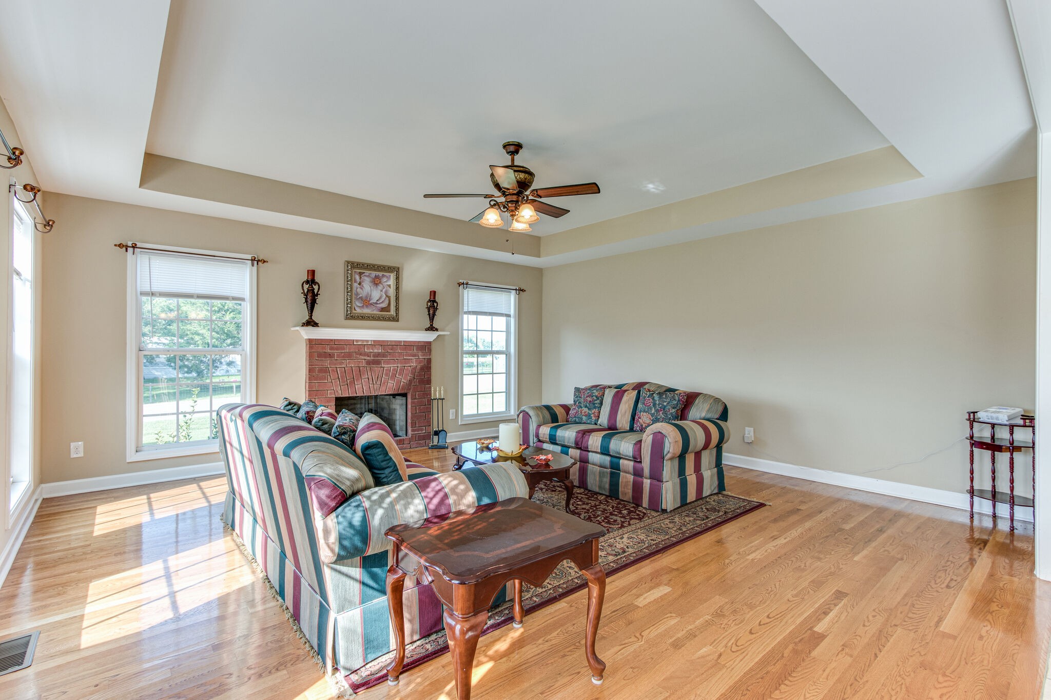 4877 Arnold Drive Murfreesboro, TN 37129 - Photo 12 of 32 a living room with furniture a fireplace and a table