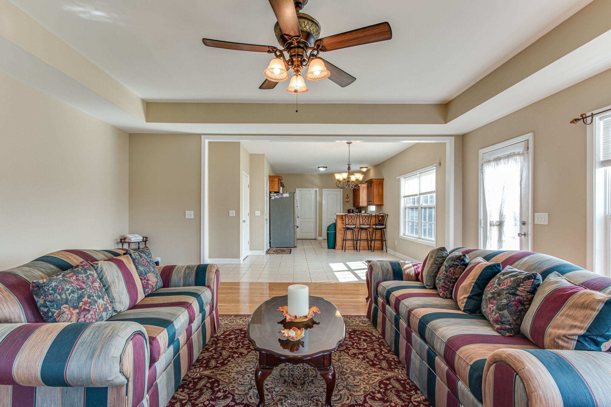 4877 Arnold Drive Murfreesboro, TN 37129 - Photo 14 of 32 a living room with furniture a rug and a chandelier