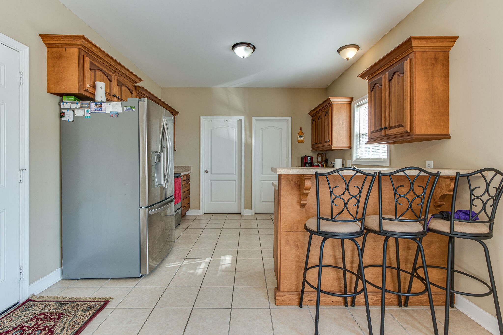 4877 Arnold Drive Murfreesboro, TN 37129 - Photo 18 of 32 a kitchen with stainless steel appliances granite countertop a refrigerator and a stove top oven