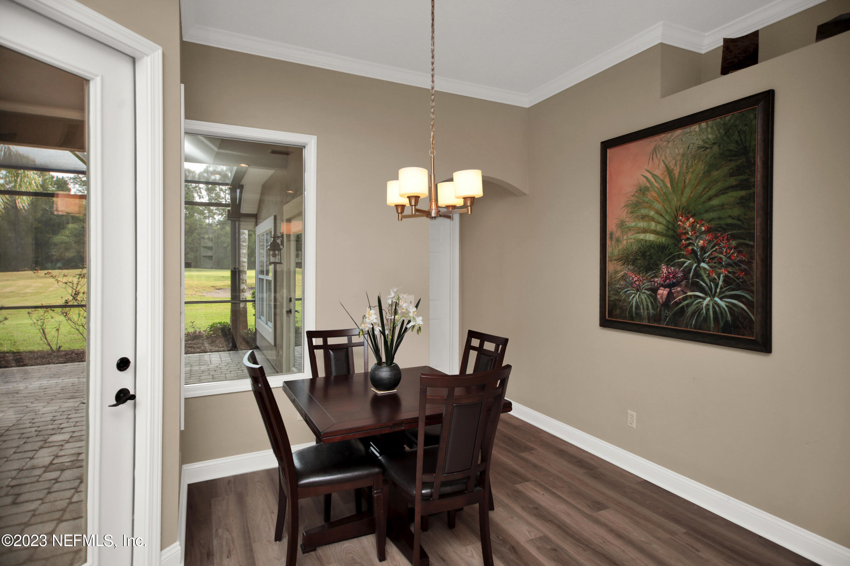 944 Oxford Drive St. Augustine, FL 32084 - Photo 15 of 58 a view of a dining room with furniture a chandelier and wooden floor
