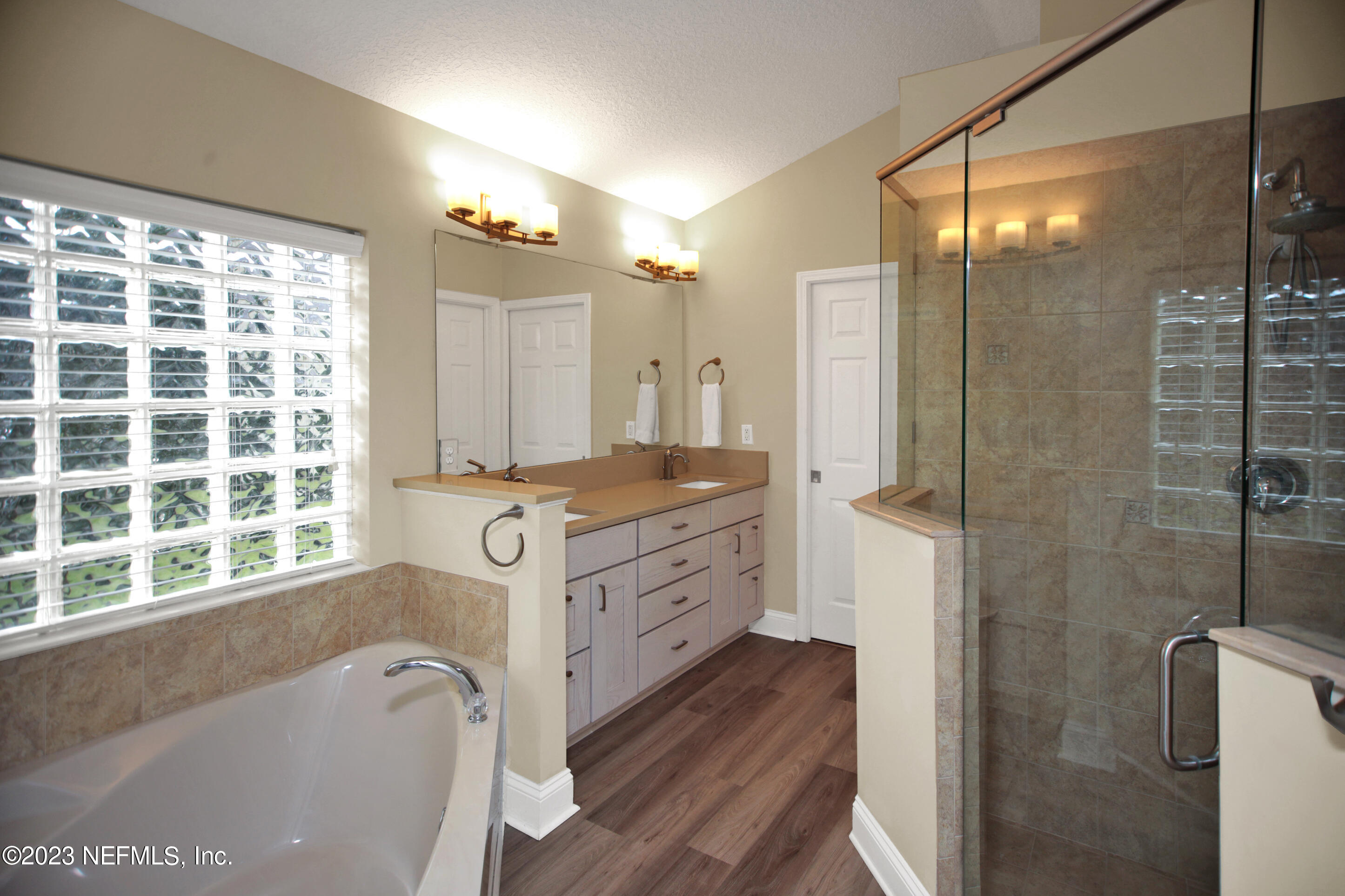 944 Oxford Drive St. Augustine, FL 32084 - Photo 20 of 58 a bathroom with a granite countertop bathtub shower sink vanity and toilet