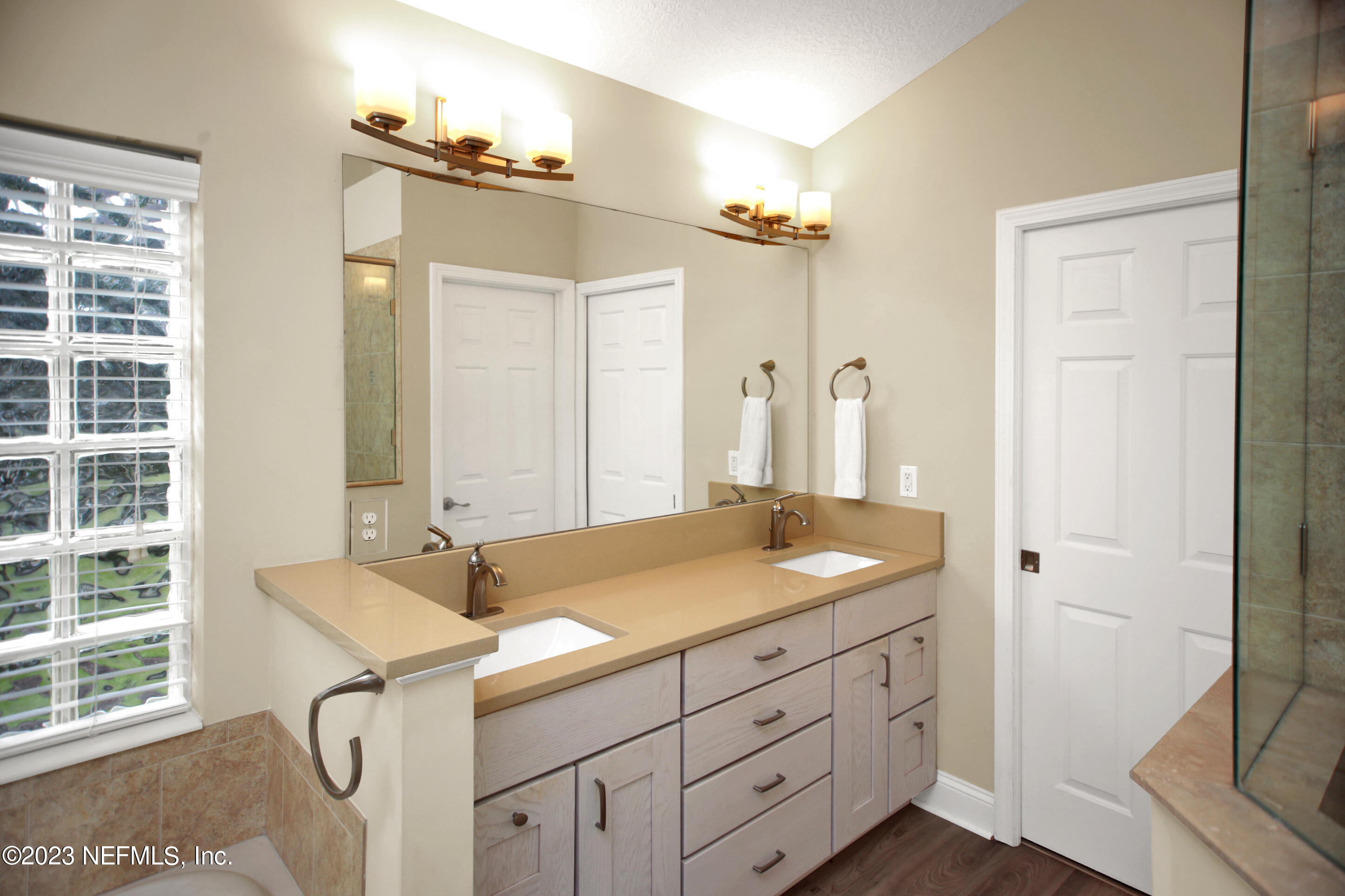 944 Oxford Drive St. Augustine, FL 32084 - Photo 21 of 58 a bathroom with a granite countertop sink and a mirror