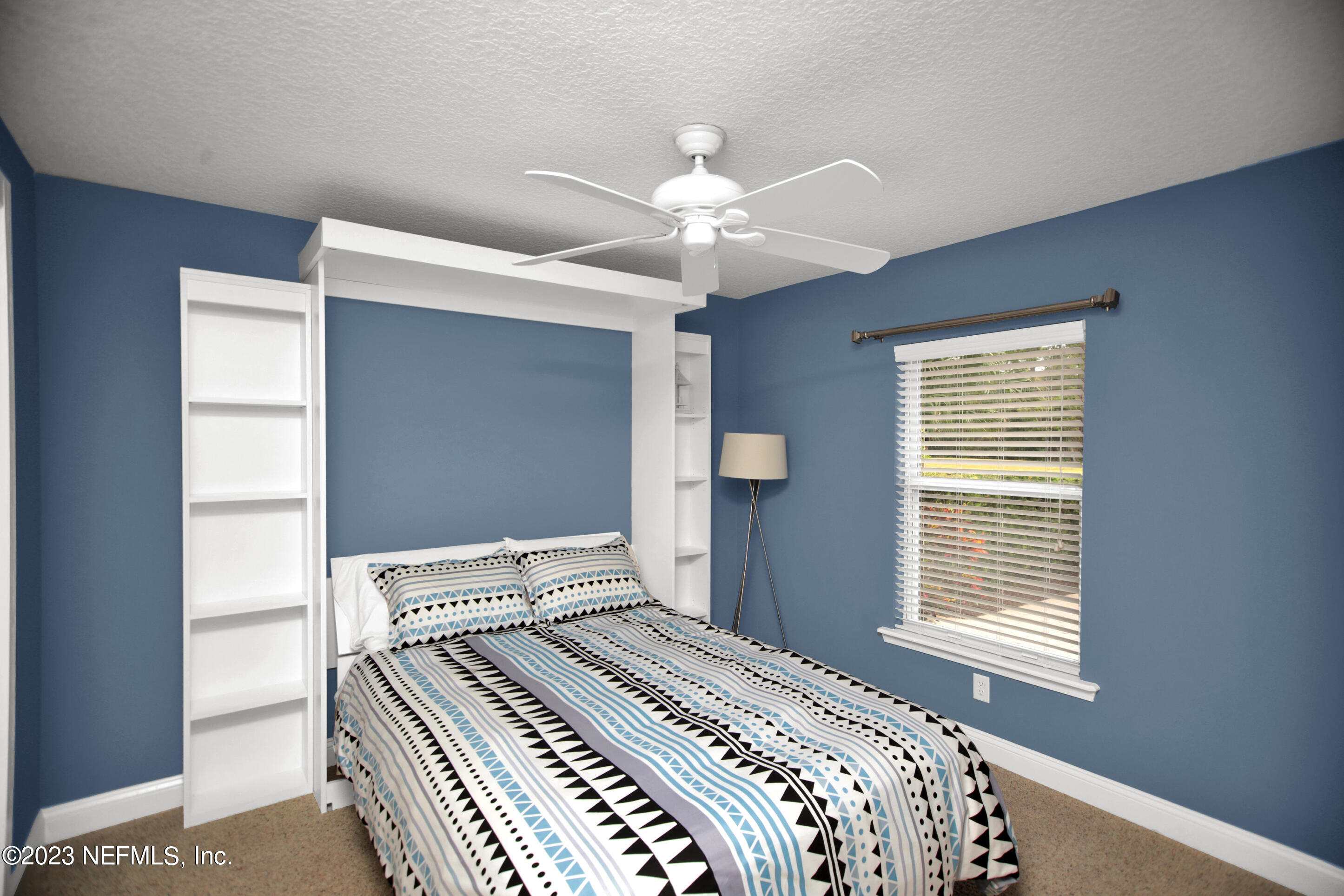 944 Oxford Drive St. Augustine, FL 32084 - Photo 27 of 58 a bedroom with a bed and a window