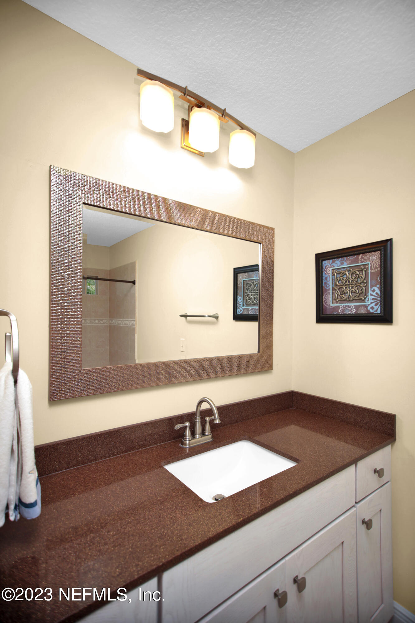 944 Oxford Drive St. Augustine, FL 32084 - Photo 30 of 58 a bathroom with a sink and a mirror