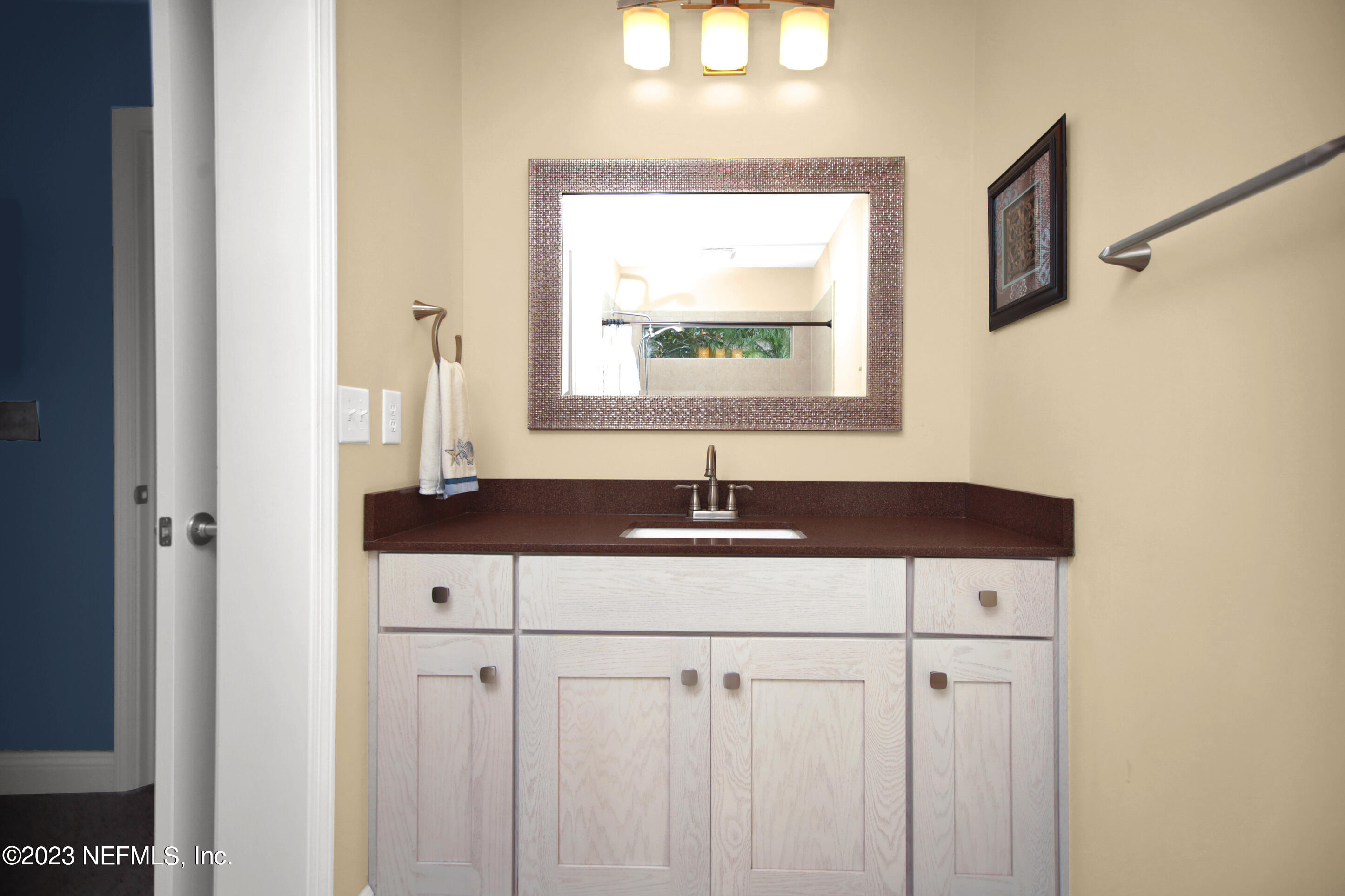 944 Oxford Drive St. Augustine, FL 32084 - Photo 32 of 58 a bathroom with a sink and a mirror