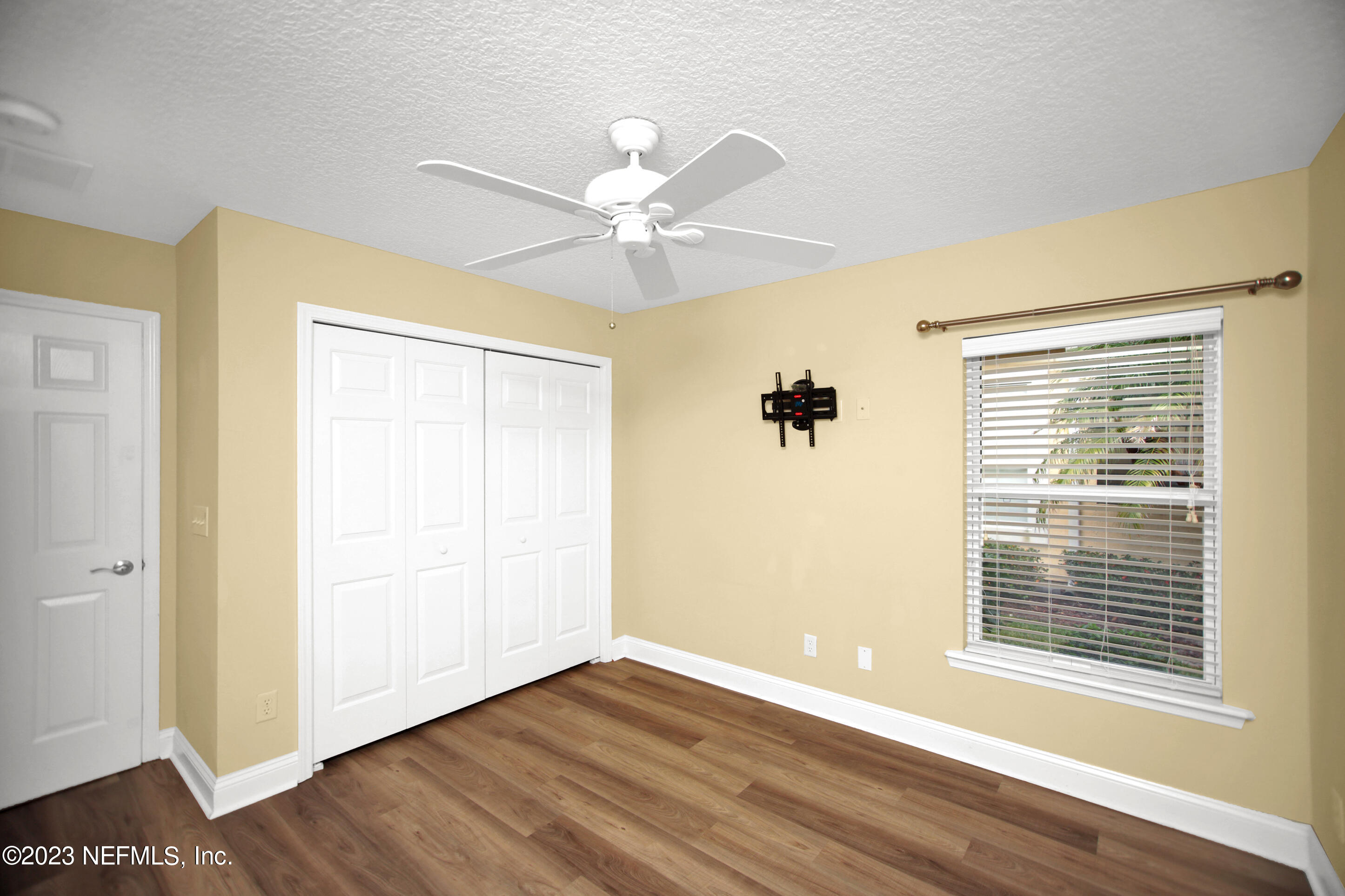 944 Oxford Drive St. Augustine, FL 32084 - Photo 37 of 58 a view of an empty room with wooden floor and a window