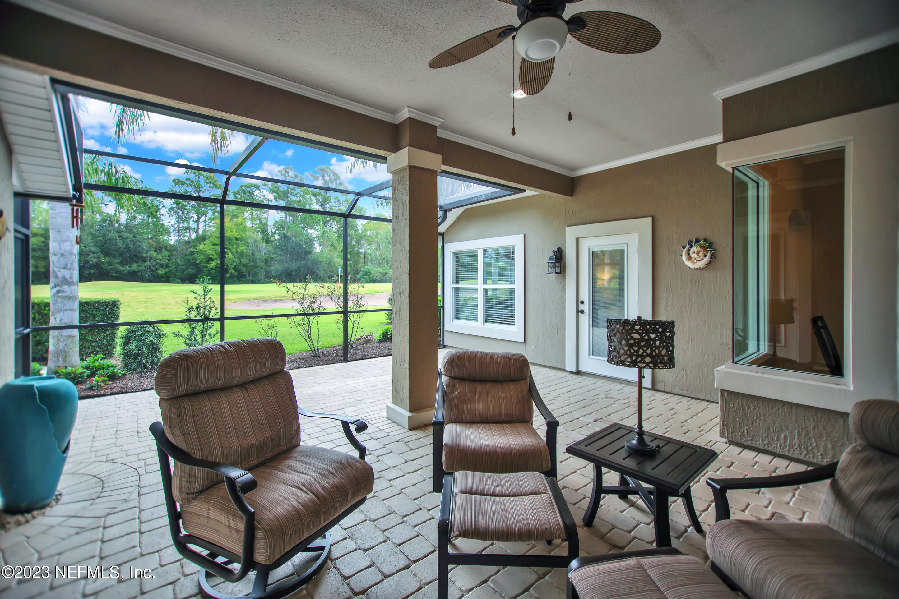 944 Oxford Drive St. Augustine, FL 32084 - Photo 39 of 58 a living room with furniture and a floor to ceiling window