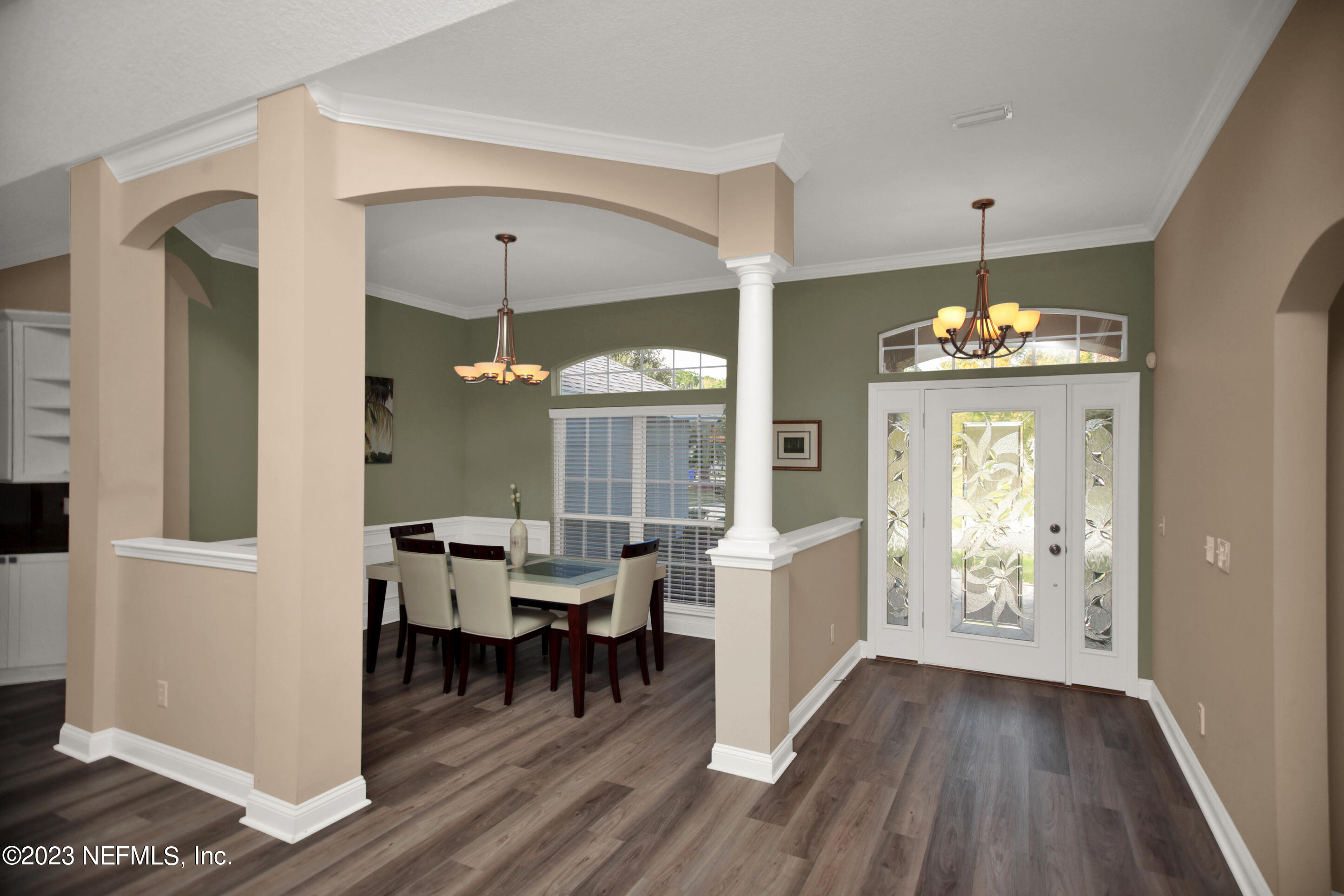 944 Oxford Drive St. Augustine, FL 32084 - Photo 5 of 58 a dining room with wooden floor a chandelier a wooden table and chairs