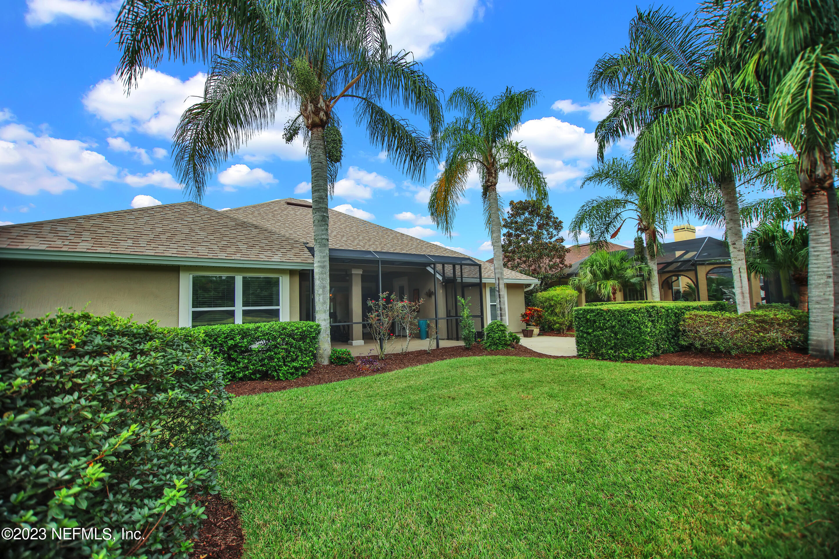 944 Oxford Drive St. Augustine, FL 32084 - Photo 51 of 58 front view of a house with a yard and palm trees