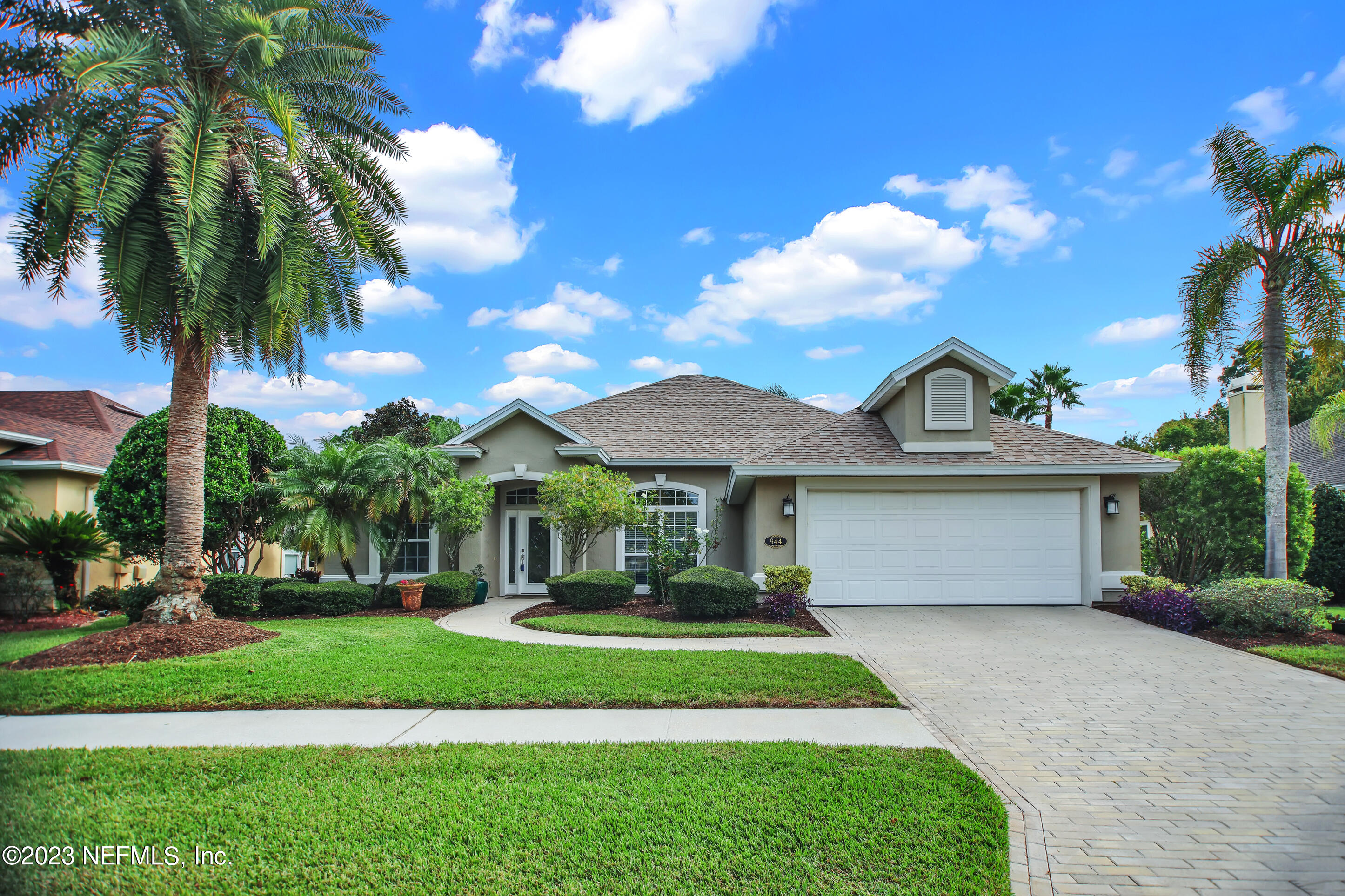 944 Oxford Drive St. Augustine, FL 32084 - Photo 58 of 58 a front view of a house with a garden and trees