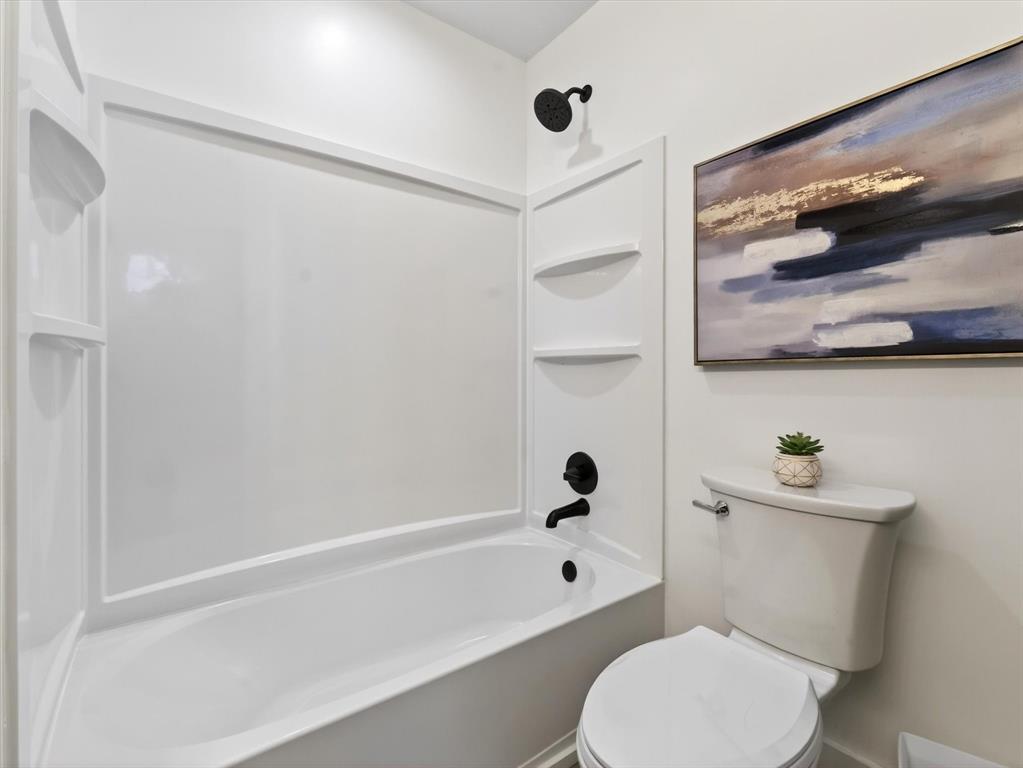 4345 Timberglen Road Dallas, TX 75287 - Photo 20 of 26 a white toilet sitting next to a bath tub and shower