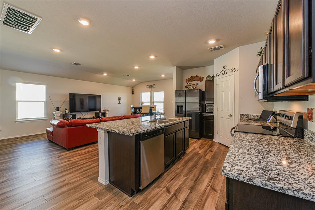 348 Jacquard Court Troy, TX 76579 - Photo 19 of 19 a large kitchen with stainless steel appliances granite countertop a lot of counter space and wooden floor