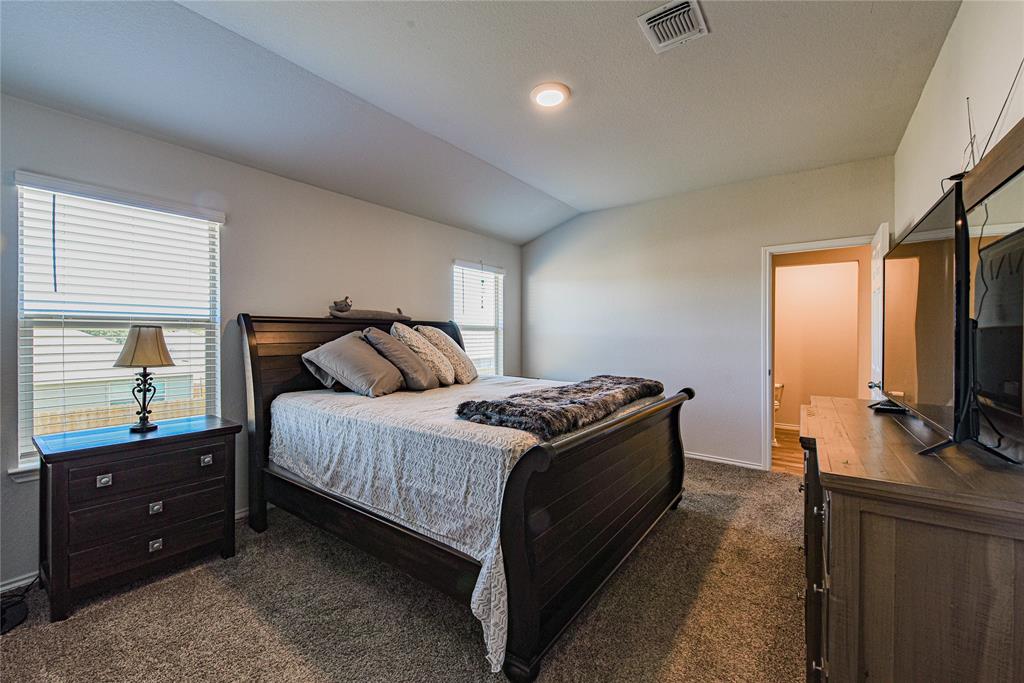 348 Jacquard Court Troy, TX 76579 - Photo 6 of 19 a bedroom with a bed and a flat tv screen on a dresser