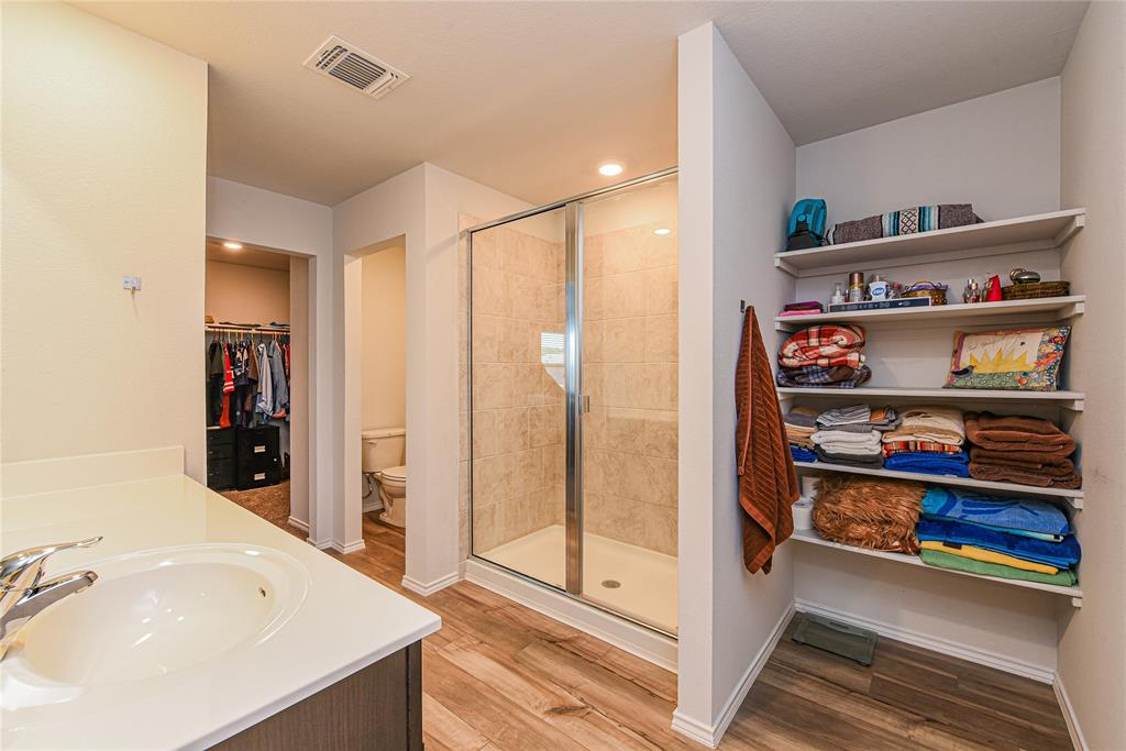 348 Jacquard Court Troy, TX 76579 - Photo 8 of 19 a en suite bathroom with a double vanity sink and a large mirror