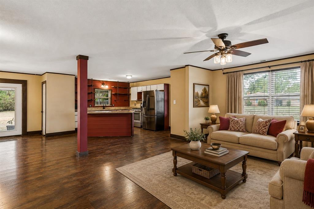 416 South Harrison Street Pilot Point, TX 76258 - Photo 4 of 20 Living Room + Kitchen (Living Room—Virtually Staged)