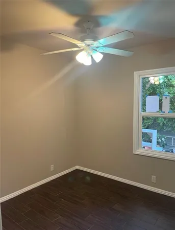a view of a small space with wooden floor and windows
