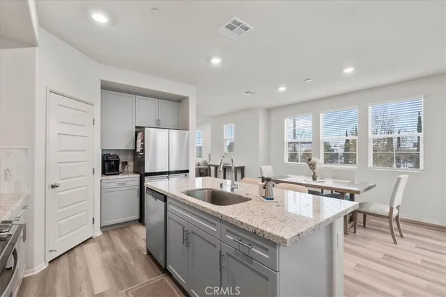 a kitchen with stainless steel appliances granite countertop a sink and dishwasher stove with wooden floor