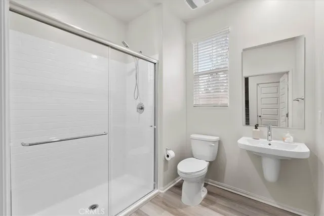 a bathroom with a toilet sink and shower