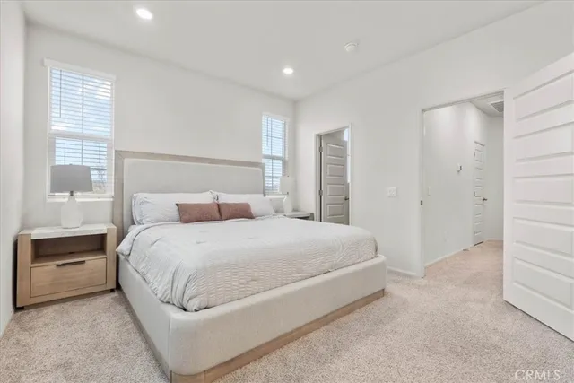 a bedroom with a bed and a night stand