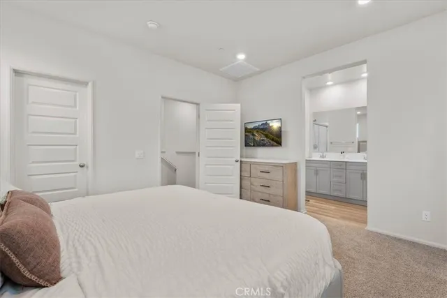 a bedroom with a bed and a television