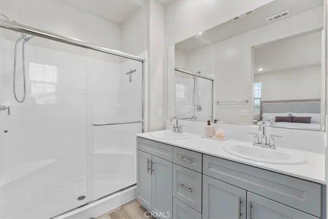 a bathroom with a shower sink and mirror