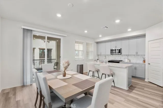 a view of a dining room with furniture and wooden floor