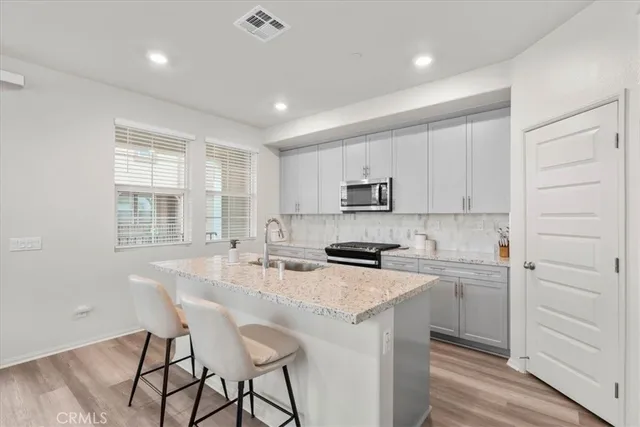 a kitchen with appliances cabinets and a counter top space