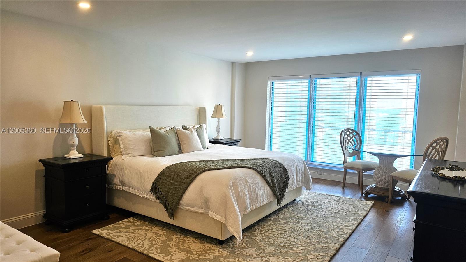 4001 North Ocean Boulevard, Unit 702 Boca Raton, FL 33431 - Photo 25 of 56 a bed room with a bed and wooden floor