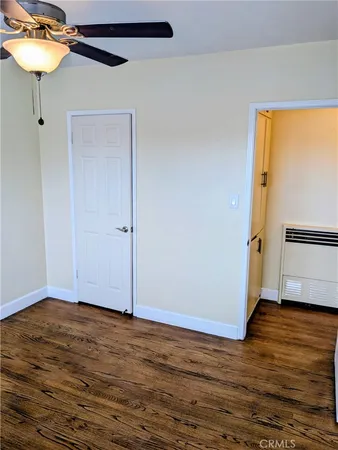 a view of a room with wooden floor and a window