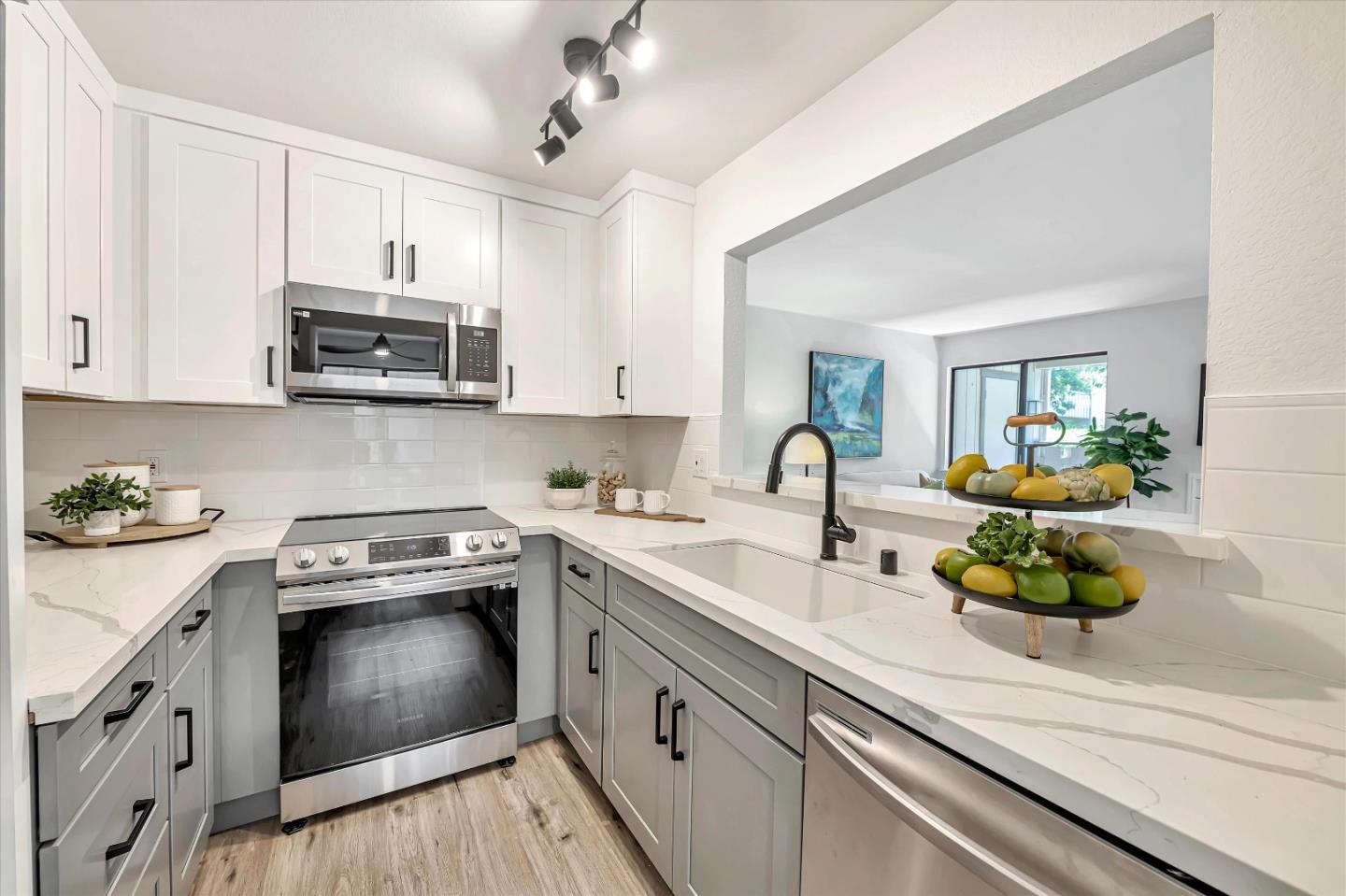 a kitchen with a sink stove and cabinets