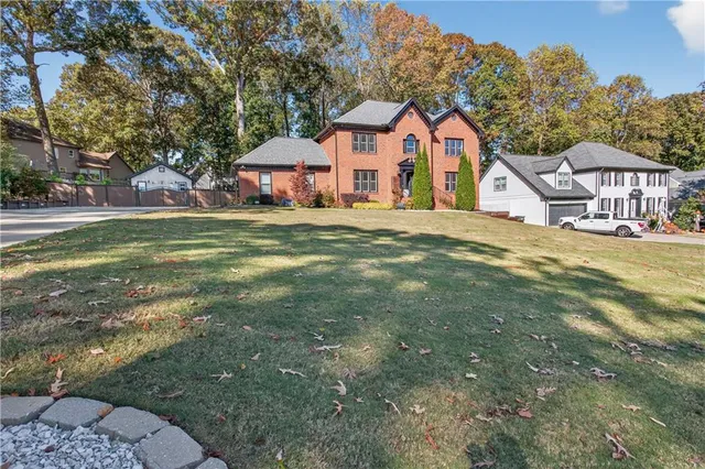 a view of a house with a yard and sitting area