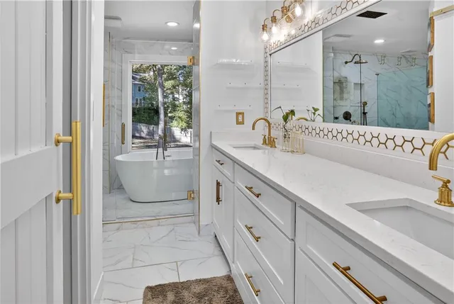 a spacious bathroom with a sink a mirror and a shower