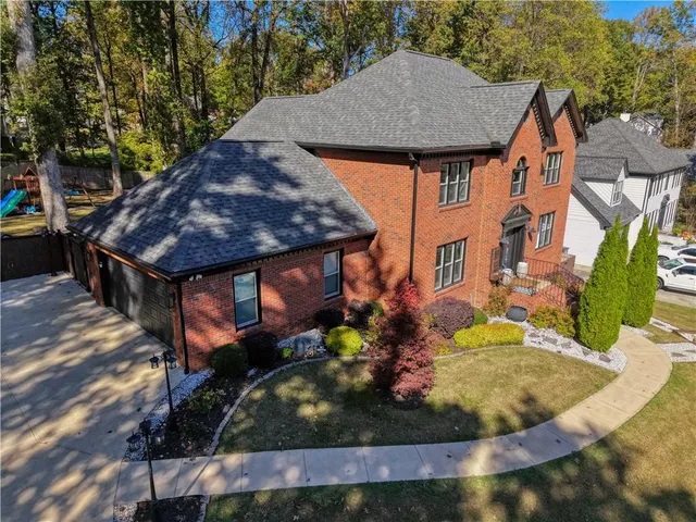 a view of a house with backyard swimming pool and sitting area
