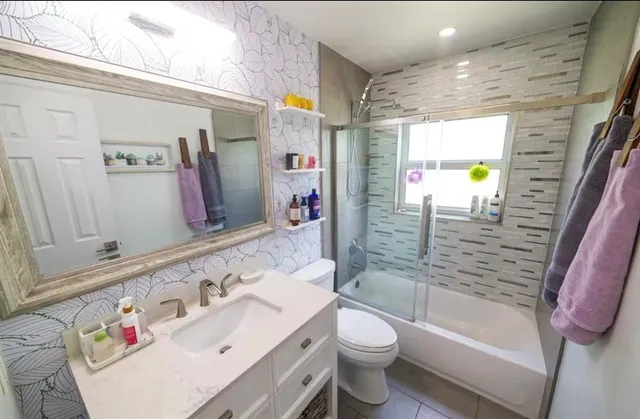 a bathroom with a sink toilet and shower