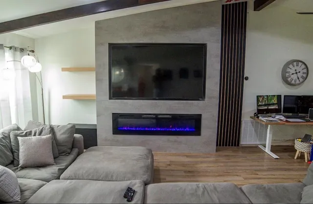 a living room with furniture and a flat screen tv