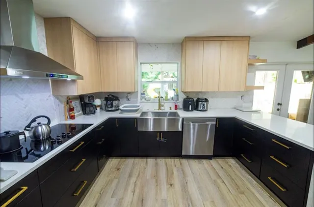 a kitchen with a sink a stove and cabinets