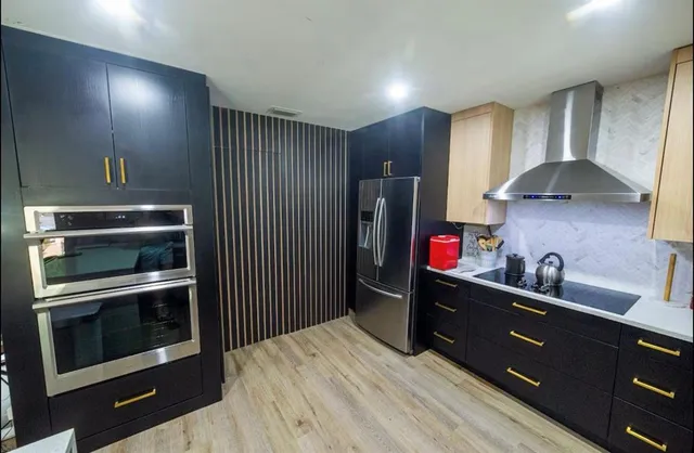 a kitchen with stainless steel appliances granite countertop a stove and a refrigerator