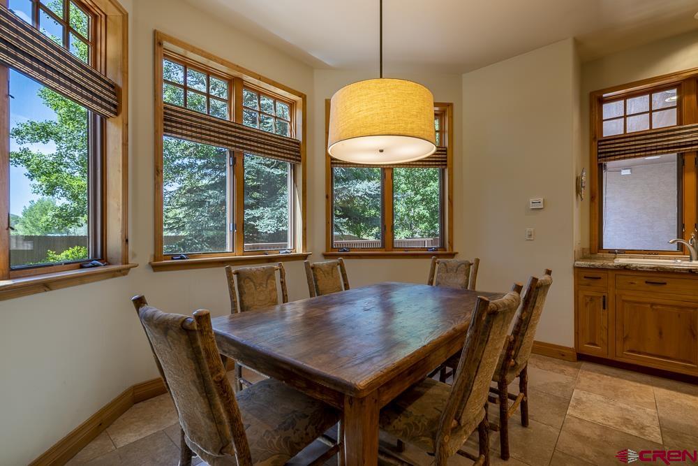 970 Red Rock Road Durango, CO 81301 - Photo 20 of 35 a view of a dining room with furniture window and wooden floor