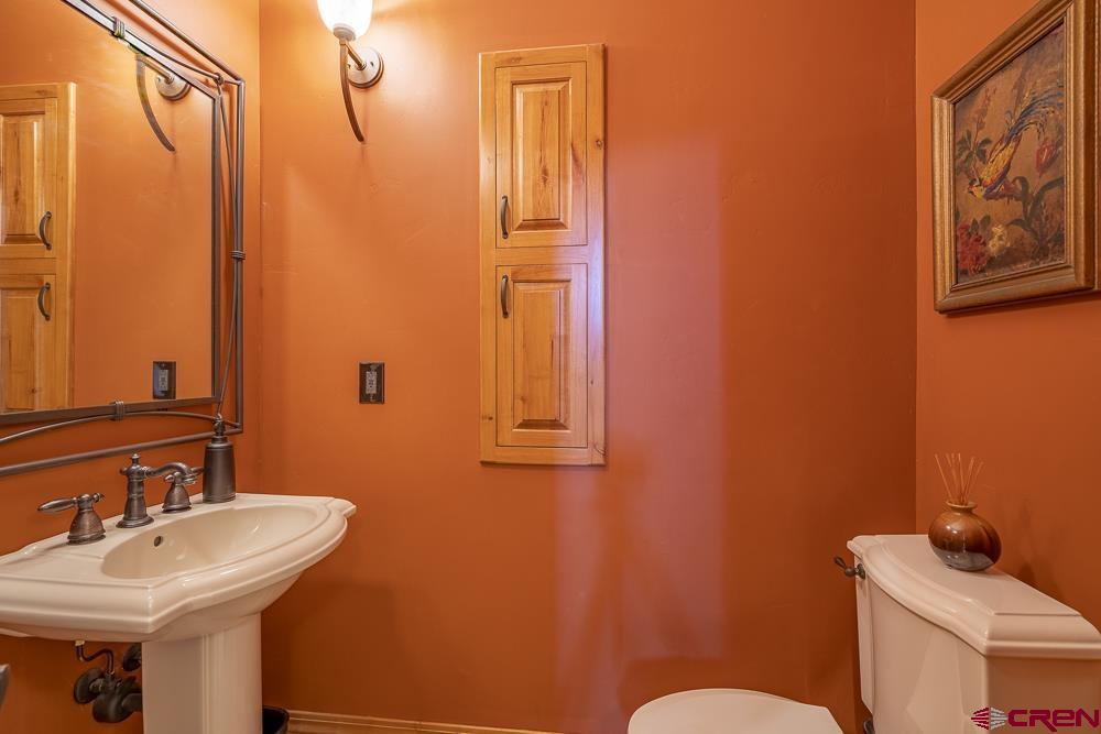 970 Red Rock Road Durango, CO 81301 - Photo 23 of 35 a bathroom with a sink a toilet and mirror