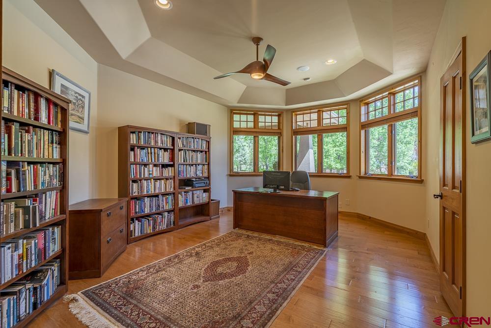 970 Red Rock Road Durango, CO 81301 - Photo 24 of 35 a living room with a large book shelf and a book shelf