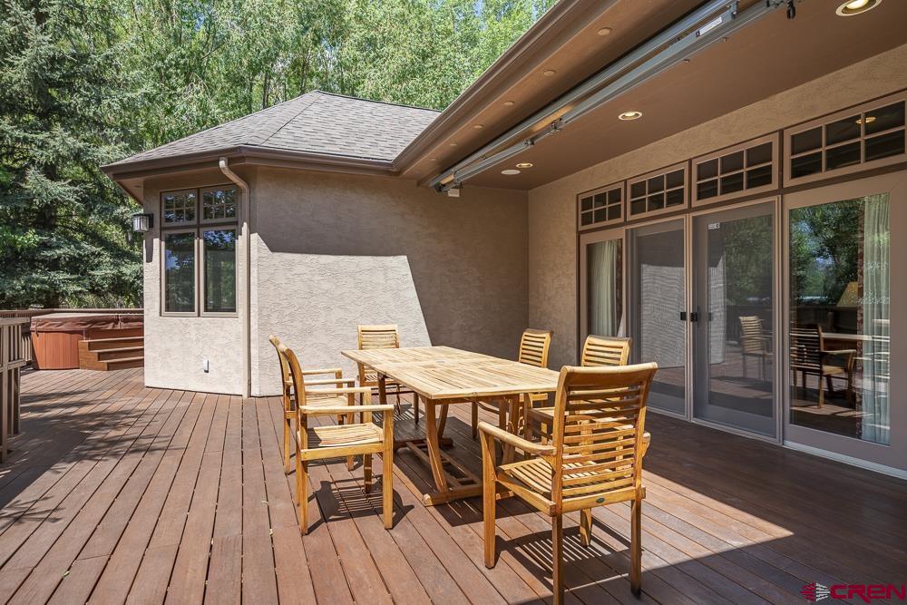 970 Red Rock Road Durango, CO 81301 - Photo 33 of 35 a view of a patio with table and chairs with wooden floor and fence